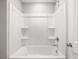 Minimalist bathtub and shower featuring a white surround and chrome fixtures at 155 Shelby Meadow Ln, Angier, NC 27501