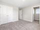 Neutral bedroom features carpet, white doors and trim, and offers ample space for relaxation at 155 Shelby Meadow Ln, Angier, NC 27501