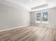 Large bedroom with two windows and modern wood-look flooring and a tray ceiling at 155 Shelby Meadow Ln, Angier, NC 27501