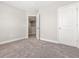 Carpeted bedroom featuring neutral walls, a doorway, and a closet door at 155 Shelby Meadow Ln, Angier, NC 27501