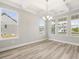 Bright dining room with large windows and a modern chandelier at 155 Shelby Meadow Ln, Angier, NC 27501