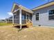 Exterior of the home showcasing the screened in porch, stairs and blue siding at 155 Shelby Meadow Ln, Angier, NC 27501