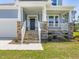 Charming front porch with stone accents and stylish stairs leading to the front door at 155 Shelby Meadow Ln, Angier, NC 27501