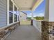 Covered front porch with stylish stone accents and an inviting exterior at 155 Shelby Meadow Ln, Angier, NC 27501