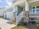 Charming front porch with stone accents and stylish stairs leading to the front door at 155 Shelby Meadow Ln, Angier, NC 27501
