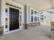 Covered front porch with stylish stone accents and an inviting black front door at 155 Shelby Meadow Ln, Angier, NC 27501