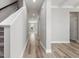 Long hallway leading to a bright room with a staircase nearby at 155 Shelby Meadow Ln, Angier, NC 27501