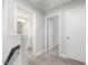 Bright hallway featuring neutral walls and carpeted floors, showcasing access to the bathroom at 155 Shelby Meadow Ln, Angier, NC 27501