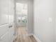 Hallway with a view of the open-concept dining room with large windows at 155 Shelby Meadow Ln, Angier, NC 27501