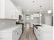 Gourmet kitchen featuring white cabinets, quartz countertops, and stainless steel appliances at 155 Shelby Meadow Ln, Angier, NC 27501