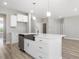 Stylish kitchen island with stainless steel dishwasher and sink plus white cabinets at 155 Shelby Meadow Ln, Angier, NC 27501