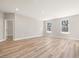 Bright living room featuring large windows and access to an adjacent room at 155 Shelby Meadow Ln, Angier, NC 27501