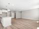 Open concept living room with hard surface floors open to the kitchen with white cabinets at 155 Shelby Meadow Ln, Angier, NC 27501