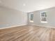 Bright, open living room with luxury vinyl plank flooring and natural light from dual windows at 155 Shelby Meadow Ln, Angier, NC 27501
