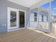 Spacious screened in back porch with wood flooring and views of the backyard at 155 Shelby Meadow Ln, Angier, NC 27501