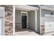 Covered entryway with stone accents and a black front door with sidelights and a transom window at 1827 Hinesley Dr, Durham, NC 27703