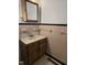 Bathroom with vintage pink tile, a wooden vanity, and a framed mirror provides a retro aesthetic at 2219 Fitzgerald Ave, Durham, NC 27707