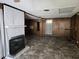 Spacious living room with a brick fireplace, paneled walls, and a ceiling fan at 2219 Fitzgerald Ave, Durham, NC 27707