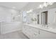 Bright bathroom showcasing double vanity, large mirror, and glass-enclosed shower at 2229 Abbeyhill Dr # 123, Raleigh, NC 27610