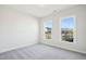 Clean and bright bedroom featuring carpeted floors and two large windows at 2229 Abbeyhill Dr # 123, Raleigh, NC 27610