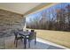 Covered patio with a dining table, fireplace, and access to an outdoor area at 2229 Abbeyhill Dr # 123, Raleigh, NC 27610