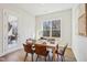 Bright dining room featuring a wooden table, six chairs, and natural light through a large window at 2229 Abbeyhill Dr # 123, Raleigh, NC 27610