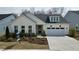 Charming single-story home with white siding, manicured landscaping, and a two-car garage at 2229 Abbeyhill Dr # 123, Raleigh, NC 27610