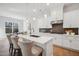 Modern kitchen island with white countertops, pendant lighting, and barstool seating at 2229 Abbeyhill Dr # 123, Raleigh, NC 27610