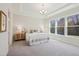 Comfortable main bedroom with large windows, tray ceiling, carpet flooring, and neutral decor at 2229 Abbeyhill Dr # 123, Raleigh, NC 27610