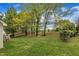 Expansive backyard with lush green grass and mature trees, offering privacy and space for outdoor activities at 3236 Forest Mill Cir, Raleigh, NC 27616