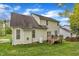 The backyard features a wooden deck, surrounded by lush green grass and mature trees at 3236 Forest Mill Cir, Raleigh, NC 27616