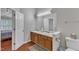Well-appointed bathroom featuring double vanity sinks and ample counter space for a functional and organized design at 3236 Forest Mill Cir, Raleigh, NC 27616