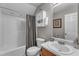 Cozy bathroom featuring a shower with curtain, single sink vanity, and mounted storage at 3236 Forest Mill Cir, Raleigh, NC 27616