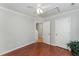 Bedroom with hardwood floors, ceiling fan, and access to hallway at 3236 Forest Mill Cir, Raleigh, NC 27616