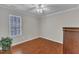 Cozy bedroom with hardwood floors, natural light, and a closet, providing a versatile space for relaxation and storage at 3236 Forest Mill Cir, Raleigh, NC 27616