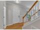 Inviting entryway with hardwood floors, a staircase, and a white front door at 3236 Forest Mill Cir, Raleigh, NC 27616