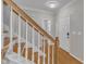 Bright entryway with hardwood floors, wooden staircase, and access to the main living areas at 3236 Forest Mill Cir, Raleigh, NC 27616