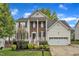 Charming two-story home featuring a brick and siding exterior, a two-car garage, and a landscaped front yard at 3236 Forest Mill Cir, Raleigh, NC 27616