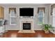 The cozy living room features an entertainment center over a fireplace with tile and traditional molding at 3236 Forest Mill Cir, Raleigh, NC 27616