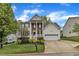 Charming two-story home with a manicured front yard and a two car garage at 3236 Forest Mill Cir, Raleigh, NC 27616