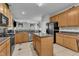 Well-equipped kitchen with stainless steel appliances, wooden cabinets, and a functional center island at 3236 Forest Mill Cir, Raleigh, NC 27616