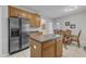 Spacious kitchen features stainless steel appliances, wood cabinets, and an island with a breakfast bar at 3236 Forest Mill Cir, Raleigh, NC 27616