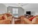 Cozy living room with vaulted ceilings, a plush couch, wood floors, and entertainment center at 3236 Forest Mill Cir, Raleigh, NC 27616