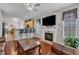 Cozy living room featuring a fireplace, dark hardwood floors, and an open layout to the kitchen at 3236 Forest Mill Cir, Raleigh, NC 27616