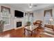 Elegant living room with a fireplace, hardwood floors, and a comfortable leather sofa at 3236 Forest Mill Cir, Raleigh, NC 27616