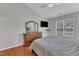 Bright main bedroom with hardwood floors and a vaulted ceiling, offering a tranquil ambiance with plenty of natural light at 3236 Forest Mill Cir, Raleigh, NC 27616