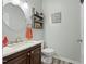 Bathroom featuring a dark vanity with a marbled countertop, and decorated shelving and mirror at 7039 Old 421 Rd, Liberty, NC 27298