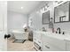 Elegant bathroom featuring a soaking tub, double sink vanity with sleek fixtures, and modern lighting at 7039 Old 421 Rd, Liberty, NC 27298