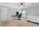 This bedroom features a fan, natural light, and room for study or relaxation, creating a calm atmosphere at 7039 Old 421 Rd, Liberty, NC 27298