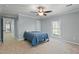 Cozy bedroom with ceiling fan, a bright window, and soft carpeting creates a relaxing retreat at 7039 Old 421 Rd, Liberty, NC 27298